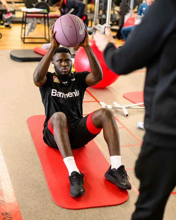 Victor Osimhen reacts after seeing photos of Victor Boniface back to Bayer Leverkusen training.