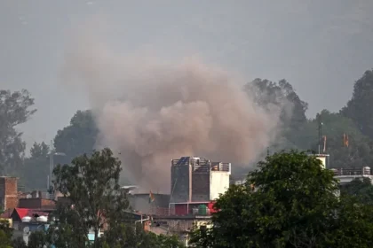 Smoke billows after an artillery shell landed in the main town of Poonch district in India