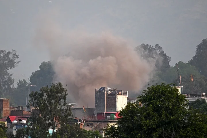 Smoke billows after an artillery shell landed in the main town of Poonch district in India