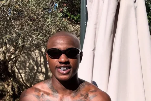 Singer Ruger Dumps Signature Pink Hair, Shows Off Tattoos in Paris