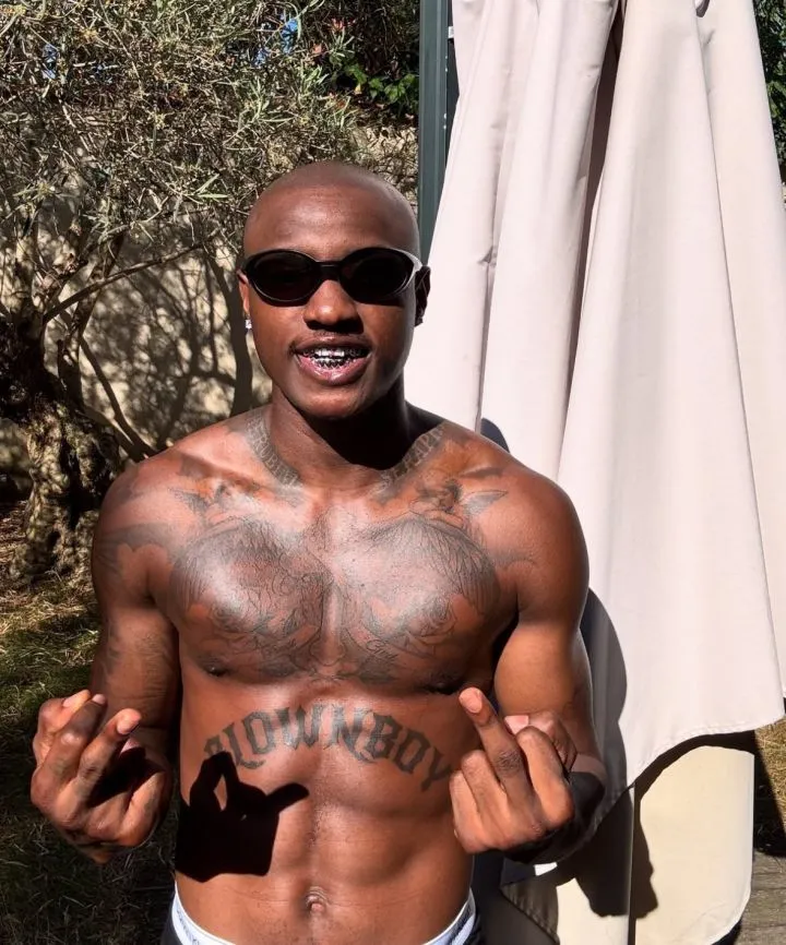 Singer Ruger Dumps Signature Pink Hair, Shows Off Tattoos in Paris