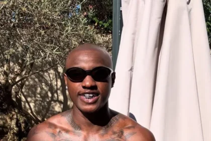 Singer Ruger Dumps Signature Pink Hair, Shows Off Tattoos in Paris